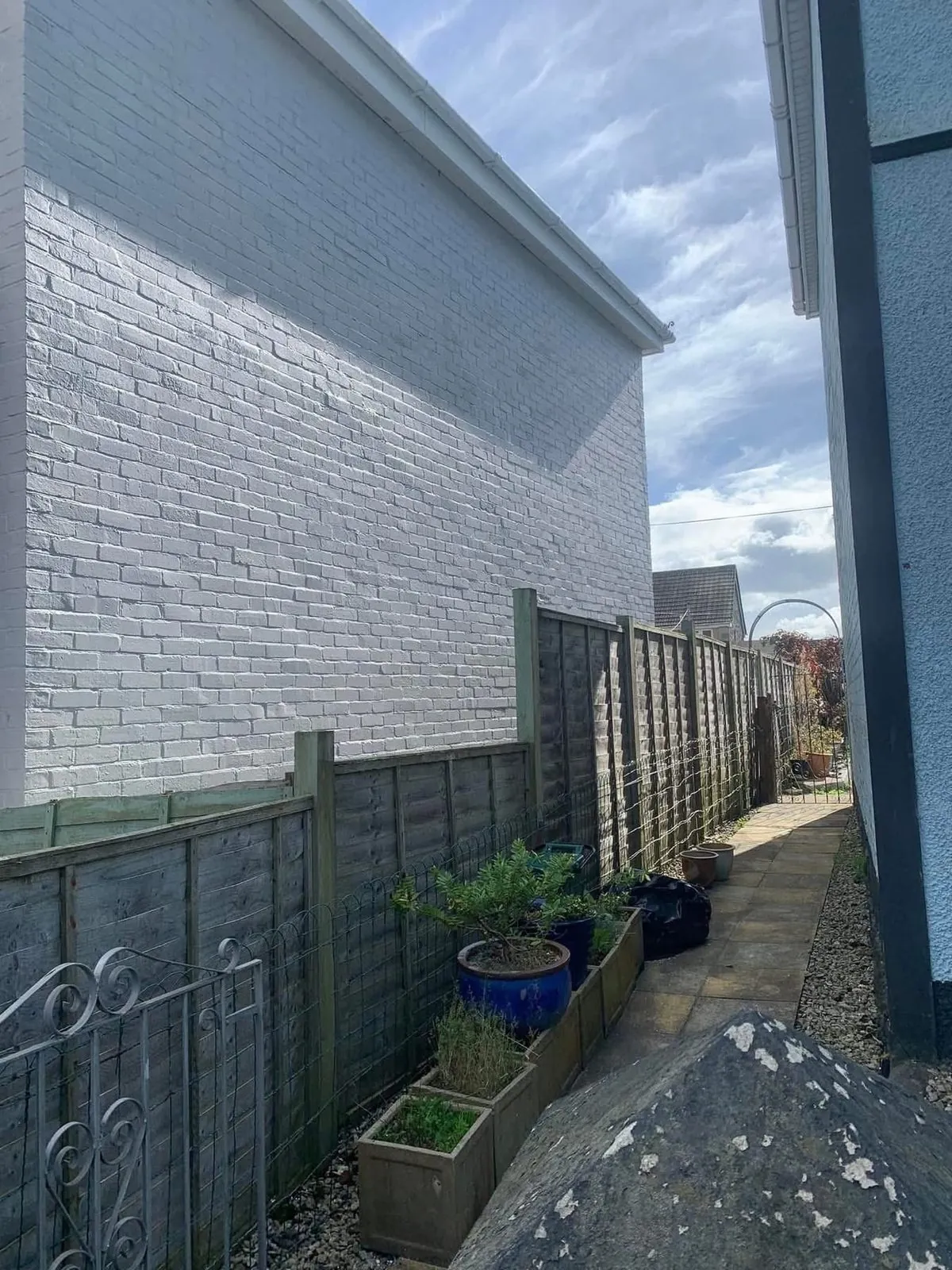Freshly painted brick wall after preparation and masonry paint in Falmouth