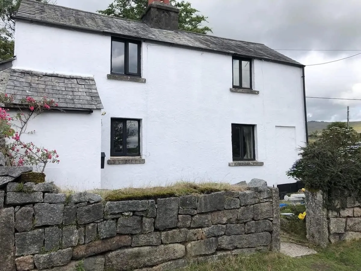 Render repair and exterior repaint of a cottage in Falmouth